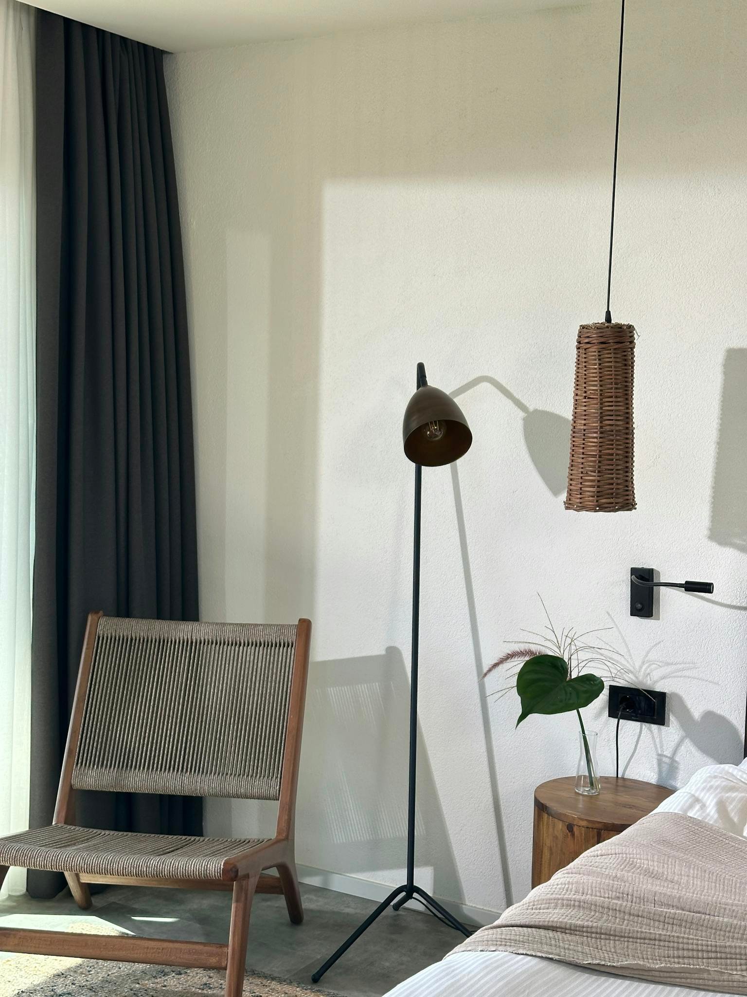 A stylish bedroom interior featuring modern furniture and natural lighting for a serene atmosphere.